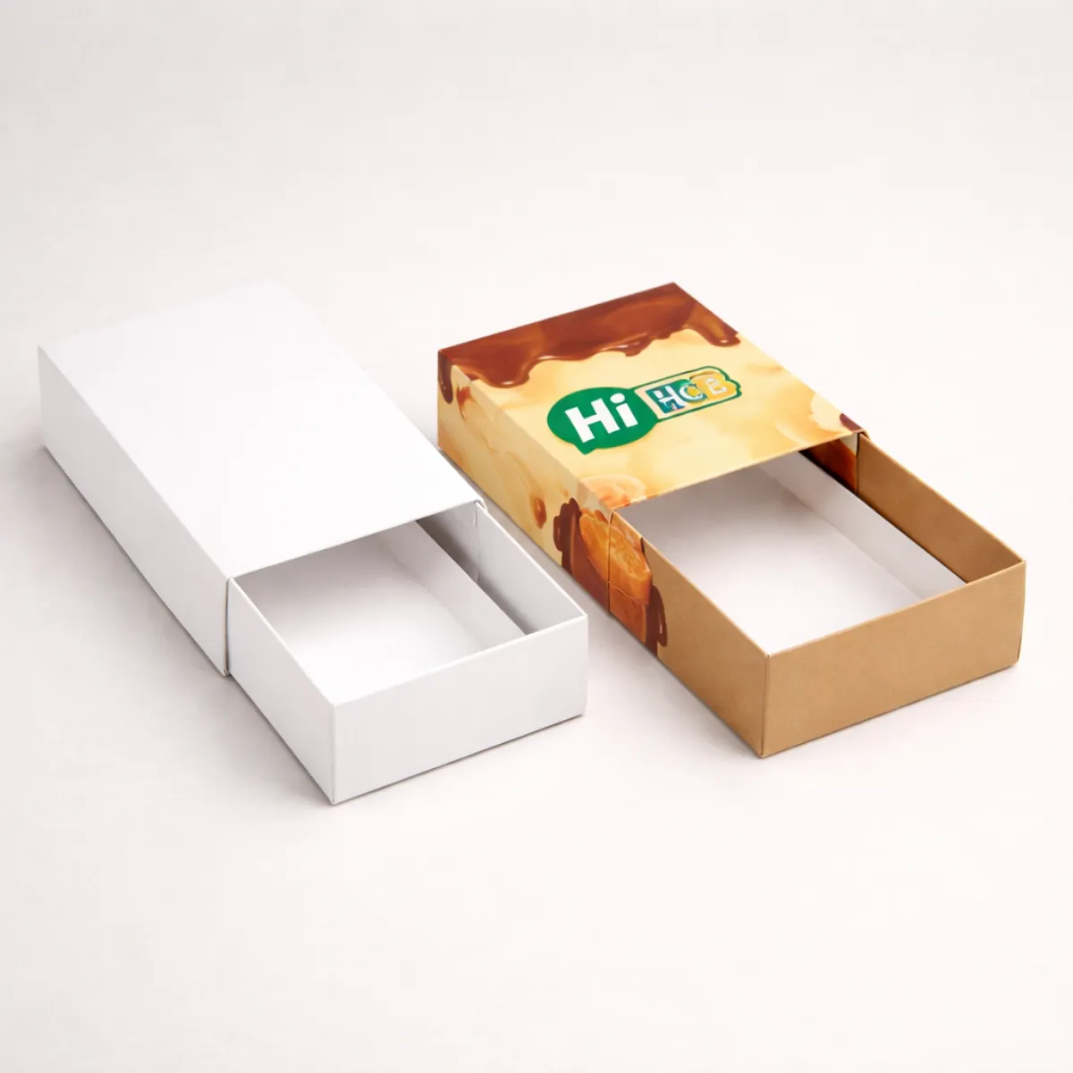 Two-piece tray and sleeve fudge boxes offering a premium sliding mechanism for high-end confectionery presentation- class=